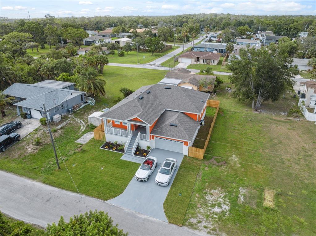 8605 Inwood Drive Hudson, FL 34667 - Photo 57 of 65 an aerial view of residential houses with outdoor space and trees