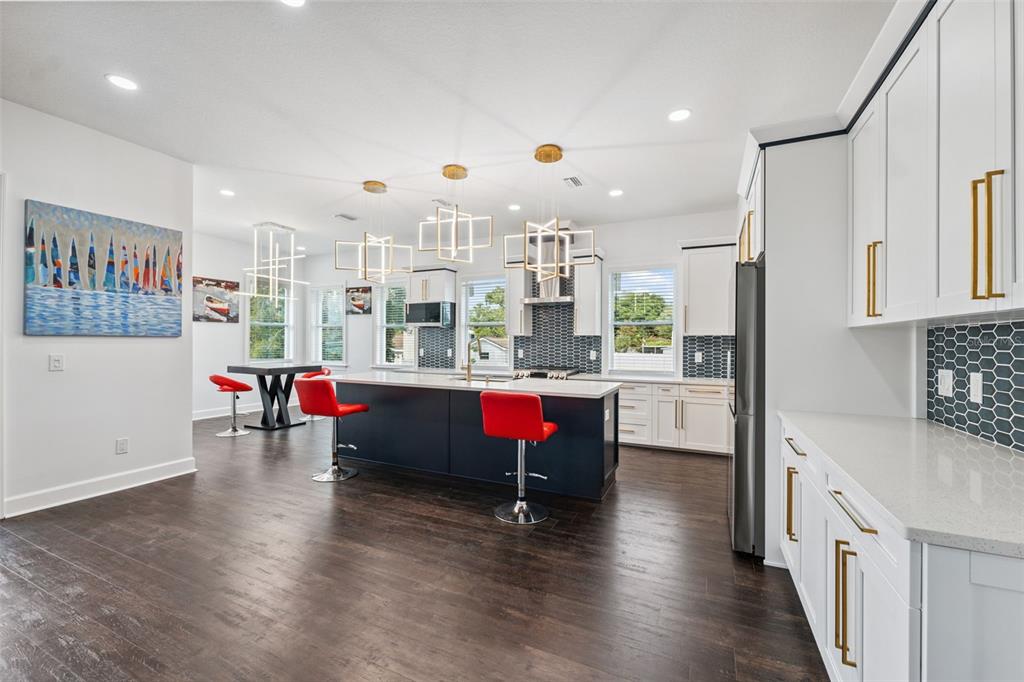 8605 Inwood Drive Hudson, FL 34667 - Photo 7 of 65 a room with stainless steel appliances kitchen island granite countertop a refrigerator a stove and white cabinets with wooden floor