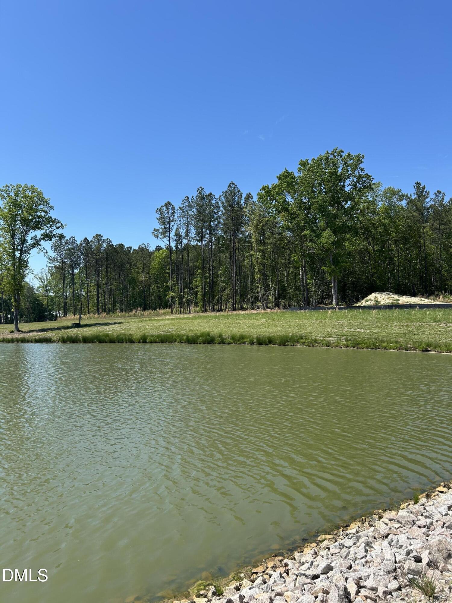 230 Bealy Farm Road Zebulon, NC 27597 - Photo 9 of 12 a view of a lake with a yard
