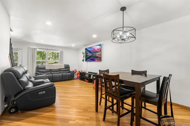 a view of a dining room with furniture wooden floor and chandelier