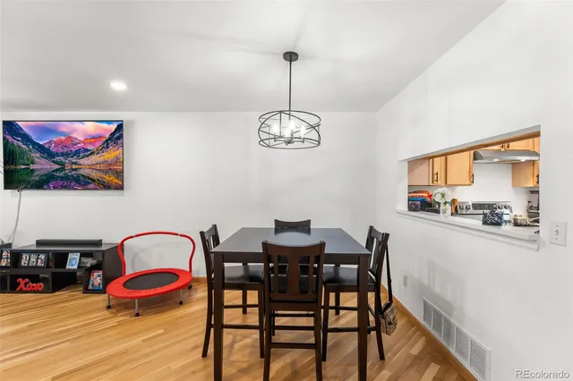 a view of a dining room with furniture wooden floor and a chandelier