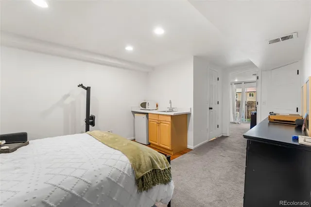 a bedroom with a bed and a view of cabinet