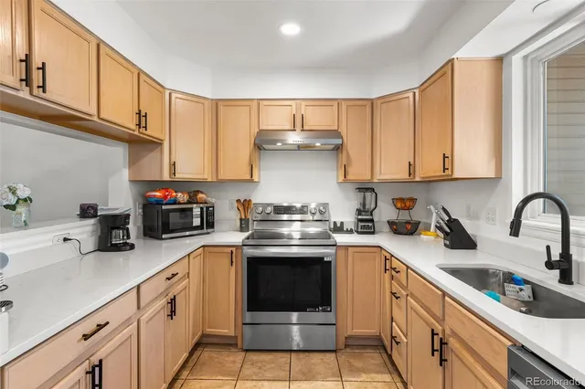 a kitchen with stainless steel appliances granite countertop a sink and cabinets