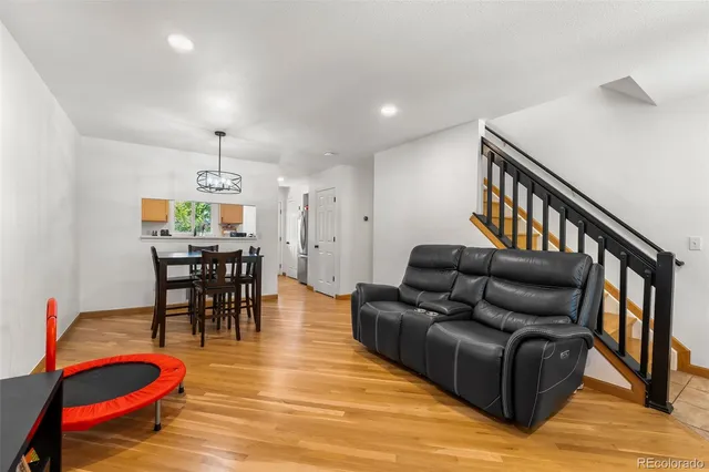 a living room with furniture and a dining table