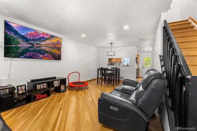 a dining room with furniture and wooden floor