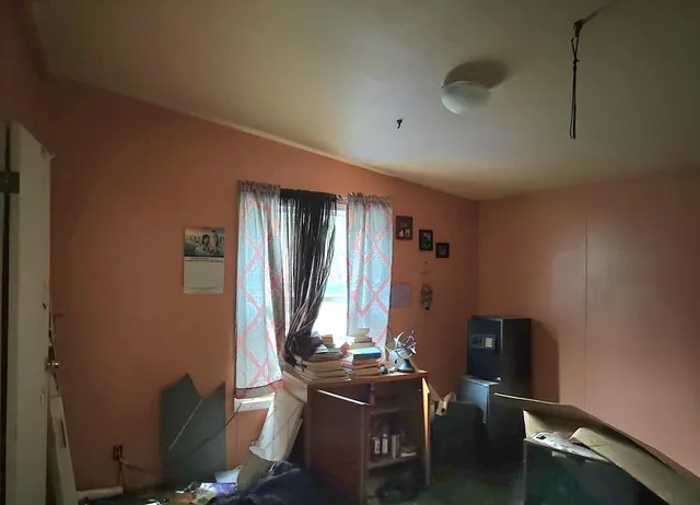 a living room with furniture window and a flat screen tv