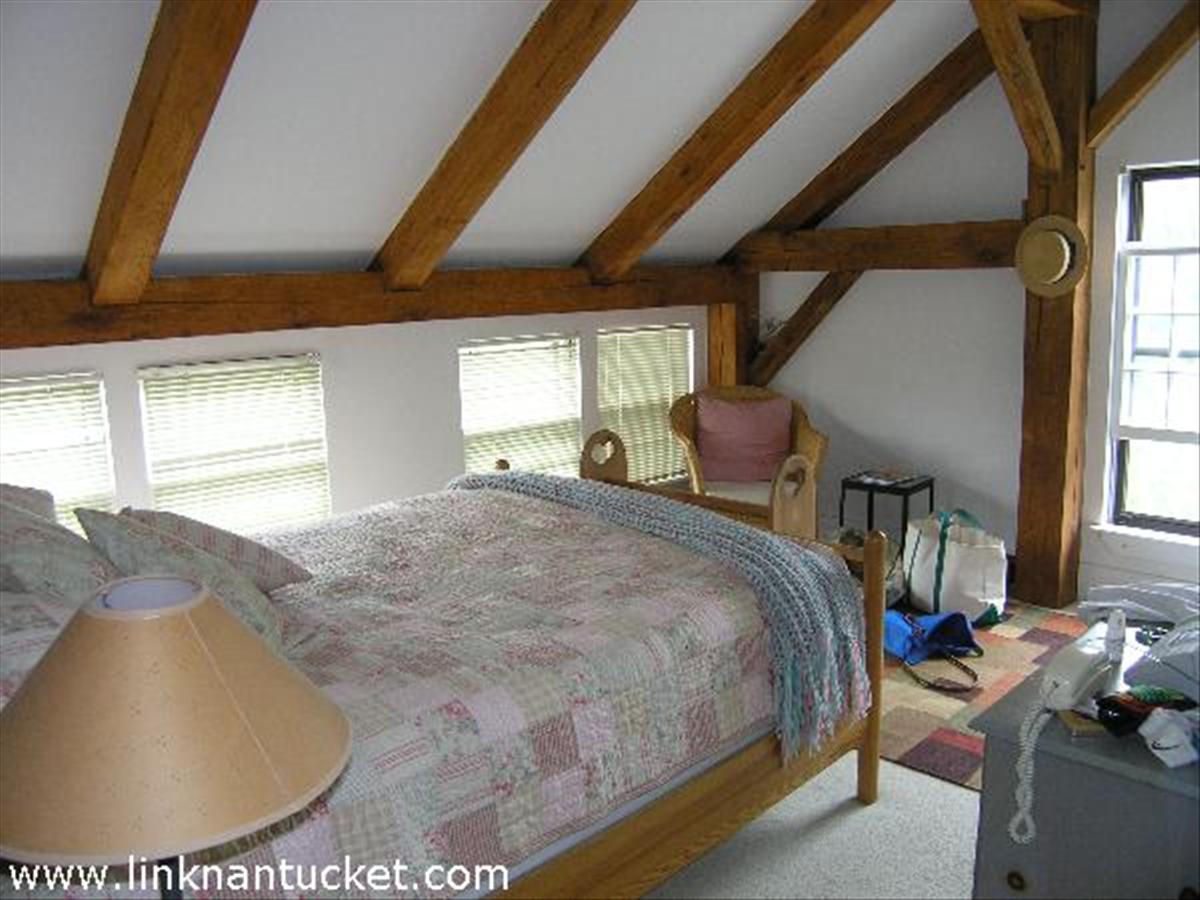 28 Miacomet Road Nantucket, MA 02554 - Photo 7 of 7 a bed sitting in a bedroom next to a window