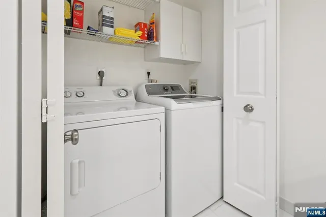 a bedroom with a bed lamp and a large window