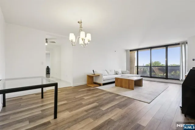 a living room with furniture and a chandelier