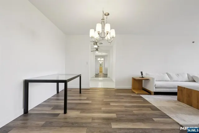 a view of a room with wooden floor and ceiling fan