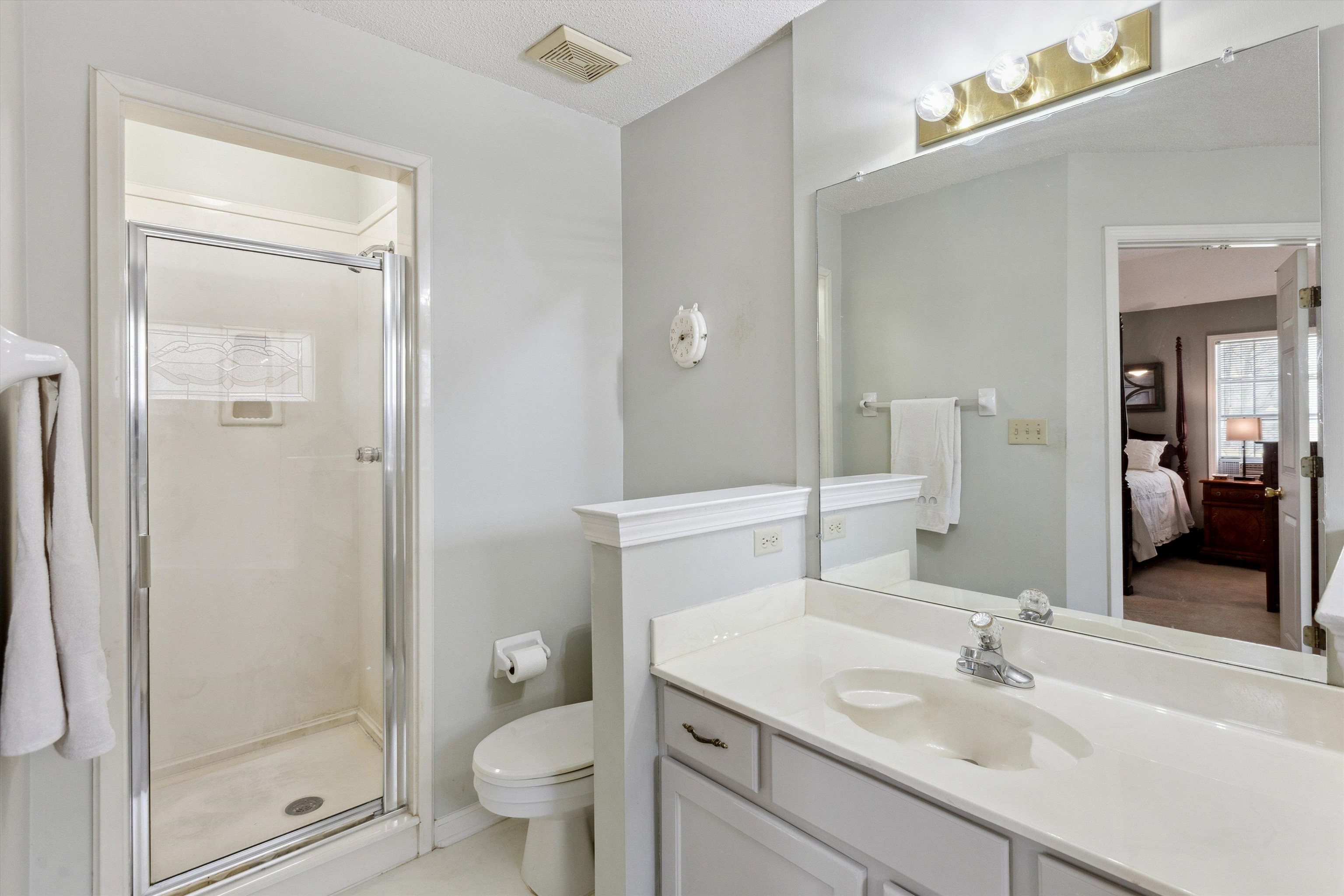 6302 Daybreak Drive Bartlett, TN 38135 - Photo 14 of 22 Bathroom featuring ensuite bath, visible vents, a stall shower, and toilet