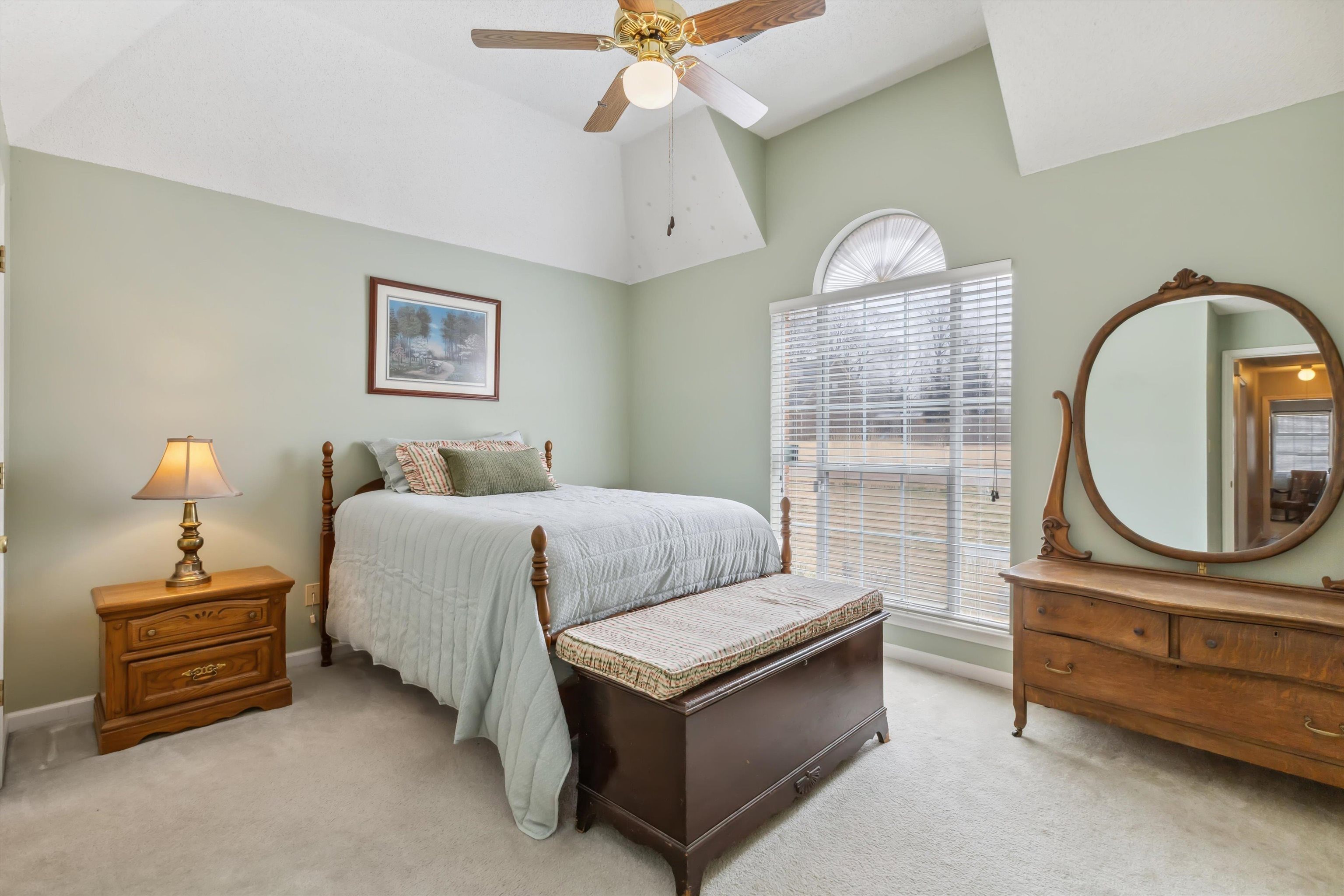 6302 Daybreak Drive Bartlett, TN 38135 - Photo 15 of 22 Bedroom featuring vaulted ceiling, multiple windows, and light colored carpet