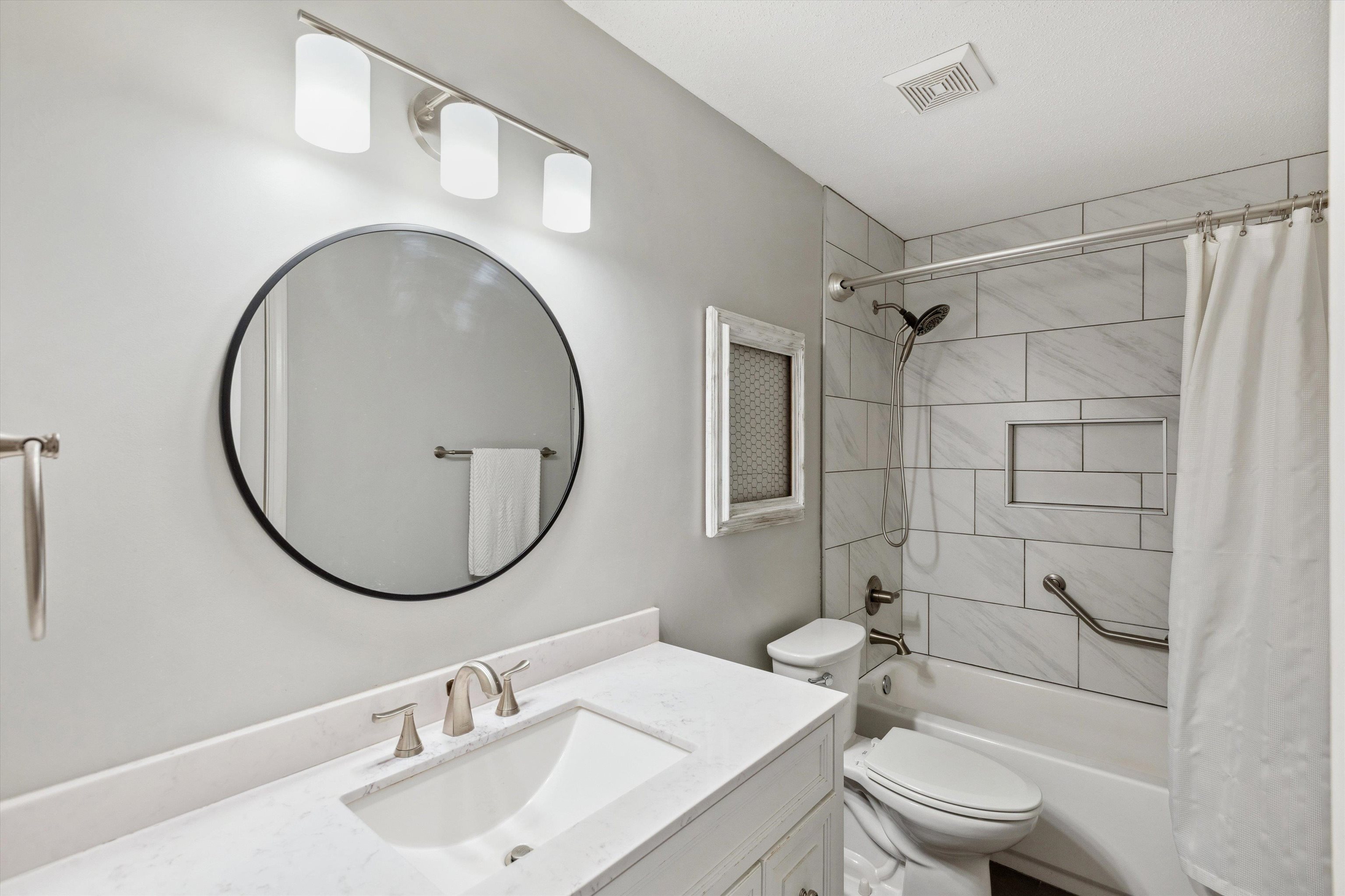 6302 Daybreak Drive Bartlett, TN 38135 - Photo 16 of 22 Bathroom with visible vents, shower / bath combo with shower curtain, toilet, and vanity