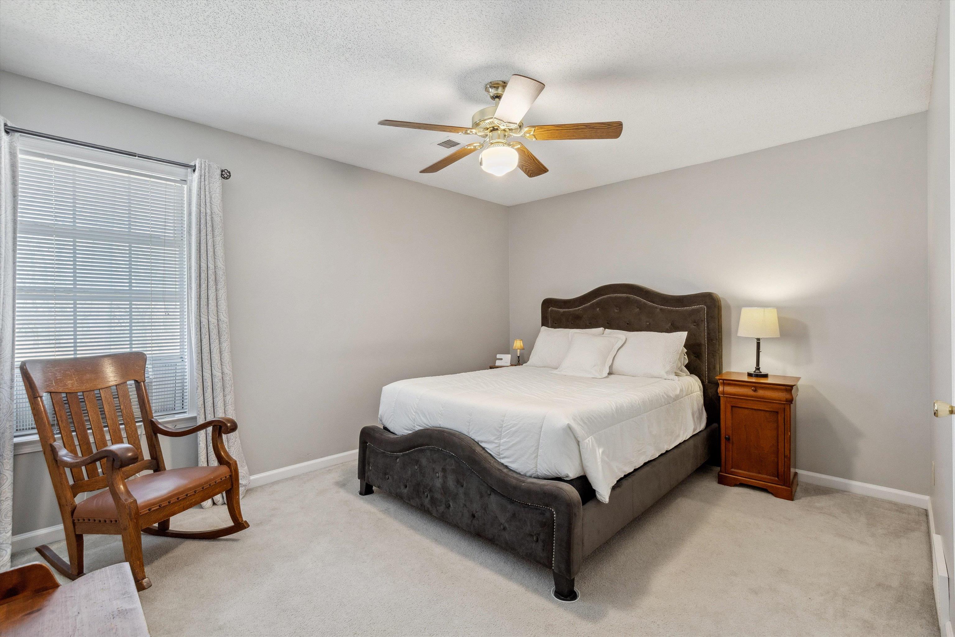 6302 Daybreak Drive Bartlett, TN 38135 - Photo 18 of 22 Bedroom featuring light colored carpet, a textured ceiling, baseboards, and ceiling fan