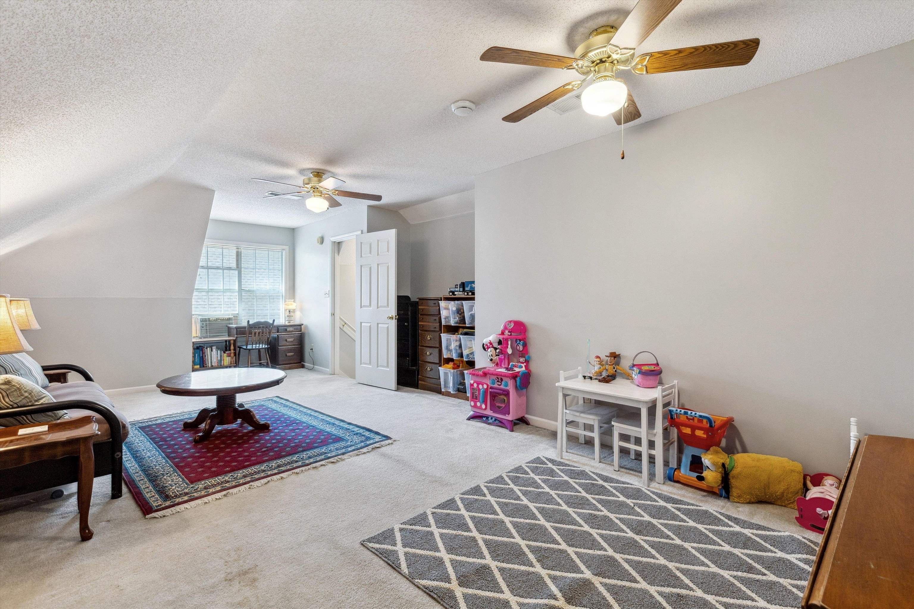 6302 Daybreak Drive Bartlett, TN 38135 - Photo 19 of 22 Game room featuring baseboards, lofted ceiling, carpet floors, a textured ceiling, and a ceiling fan