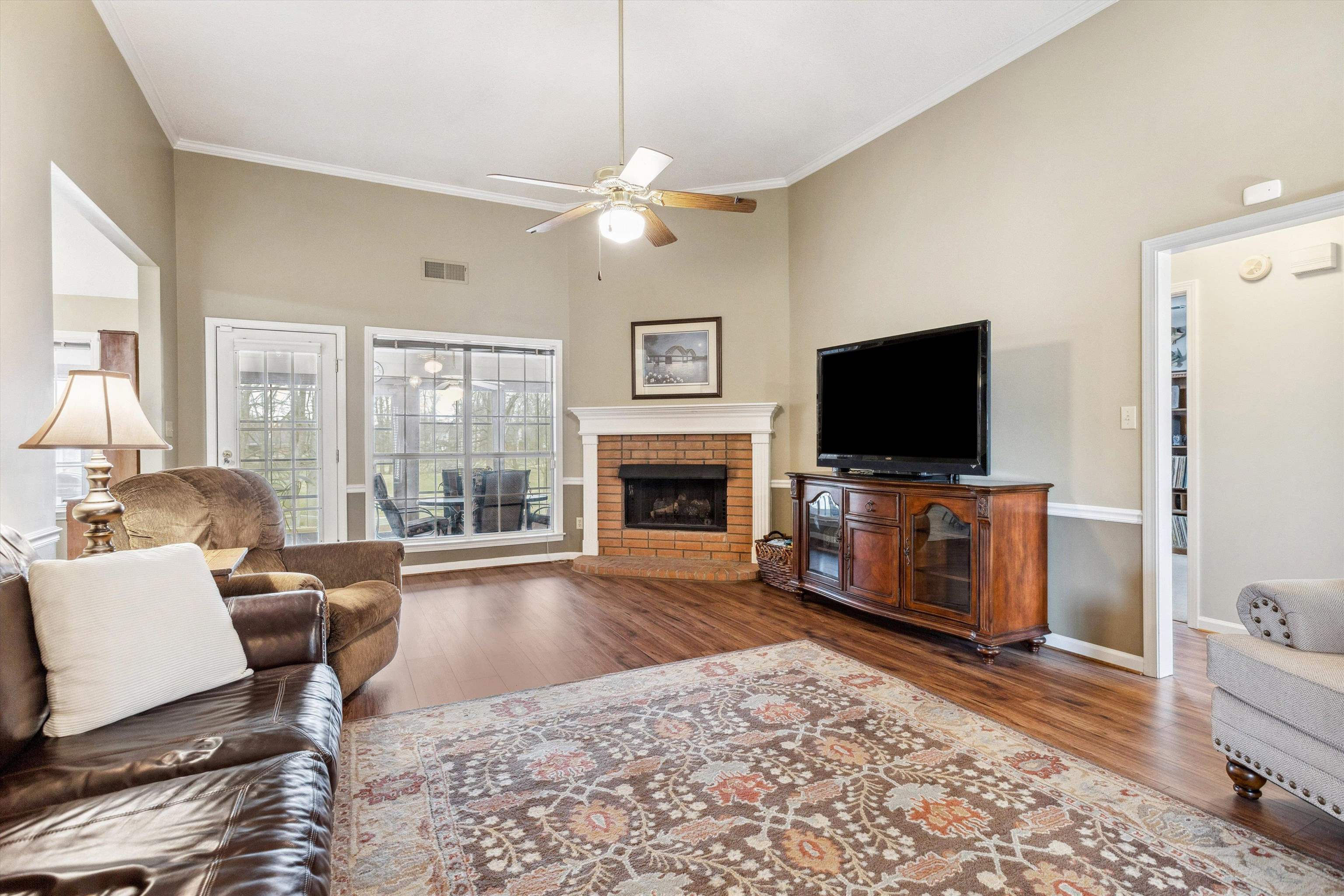 6302 Daybreak Drive Bartlett, TN 38135 - Photo 6 of 22 Living area with visible vents, wood finished floors, crown molding, baseboards, and ceiling fan