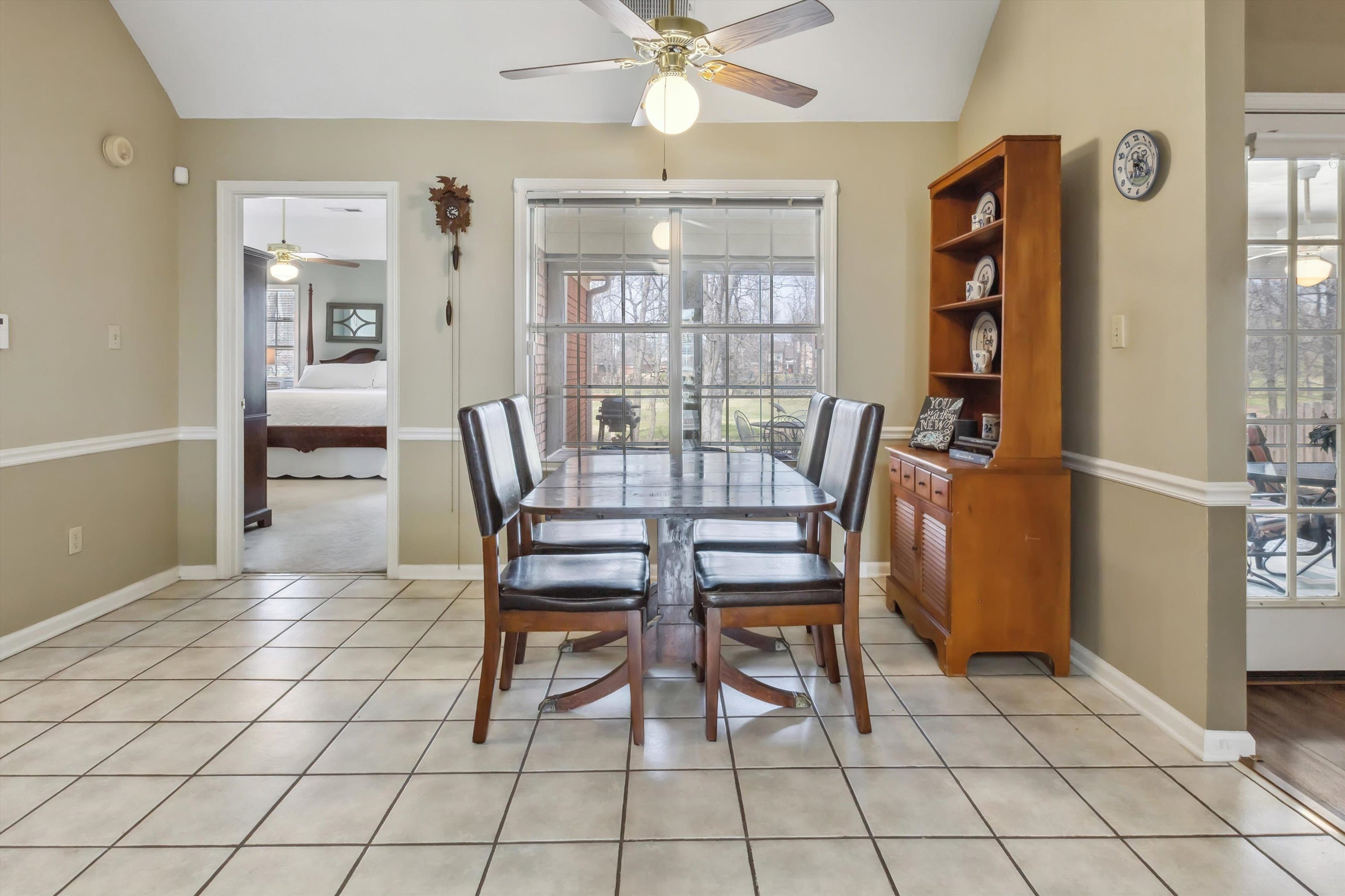 6302 Daybreak Drive Bartlett, TN 38135 - Photo 10 of 22 Dining room featuring lofted ceiling, a ceiling fan, and a wealth of natural light