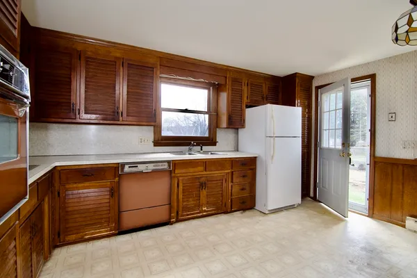 a kitchen with stainless steel appliances granite countertop a refrigerator a sink and a stove