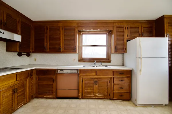 a kitchen with a refrigerator and a sink