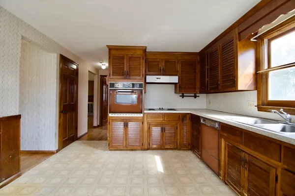 a kitchen with stainless steel appliances granite countertop a refrigerator and a sink