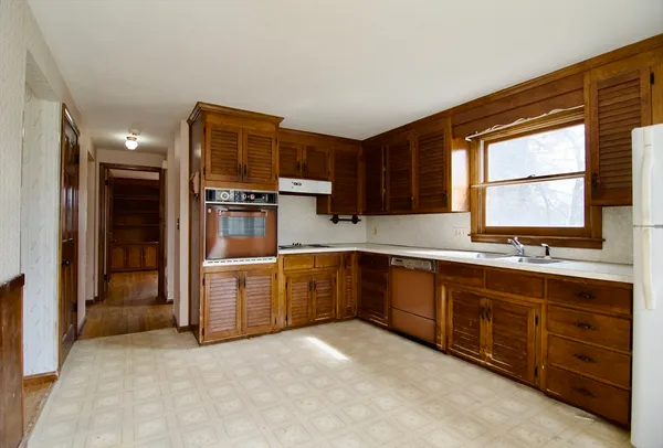 a kitchen with sink cabinets and window
