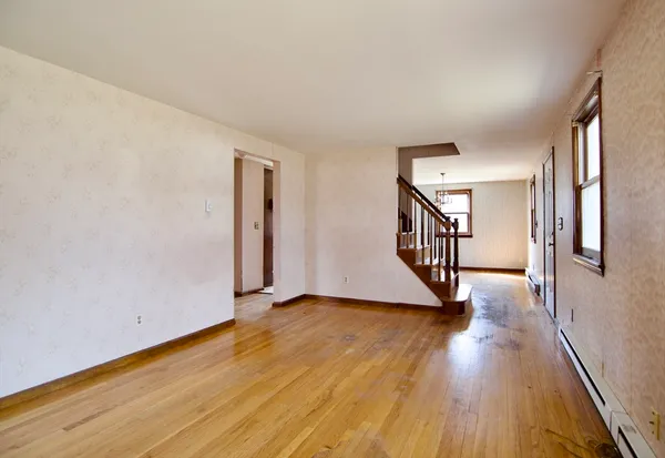 a view of an entryway with wooden floor