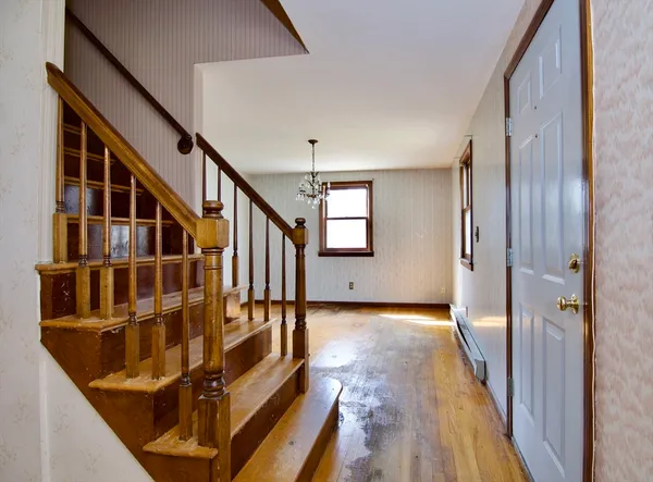 a view of an entryway with wooden floor and stairs