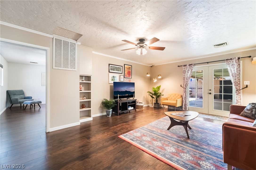 1324 Appaloosa Road Boulder City, NV 89005 - Photo 15 of 38 Rich wood flooring runs through this open living space featuring classic French doors.