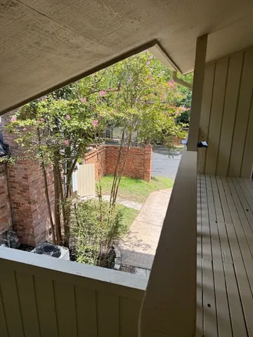 a view of balcony with wooden floor