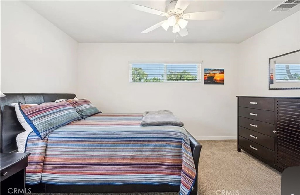 5340 East Mezzanine Way Long Beach, CA 90808 - Photo 11 of 18 a bedroom with a bed and a chandelier