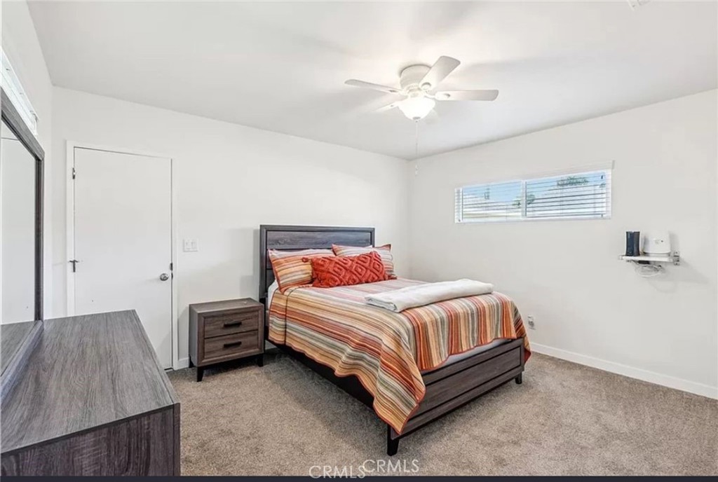 5340 East Mezzanine Way Long Beach, CA 90808 - Photo 12 of 18 a bedroom with a bed and a chandelier