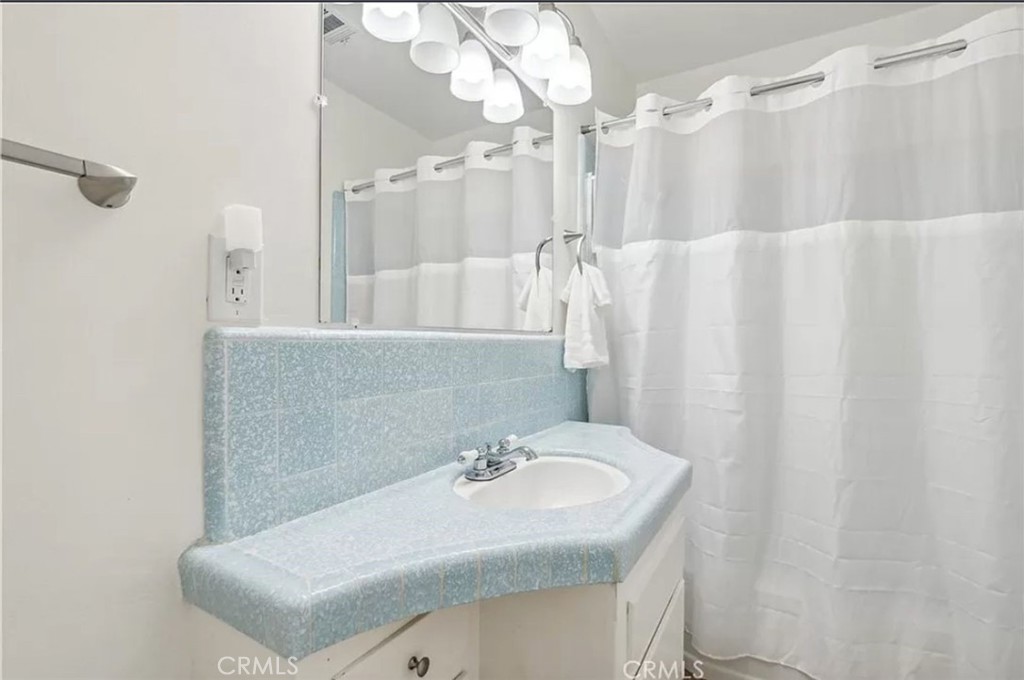 5340 East Mezzanine Way Long Beach, CA 90808 - Photo 14 of 18 a bathroom with a sink vanity granite tub and shower