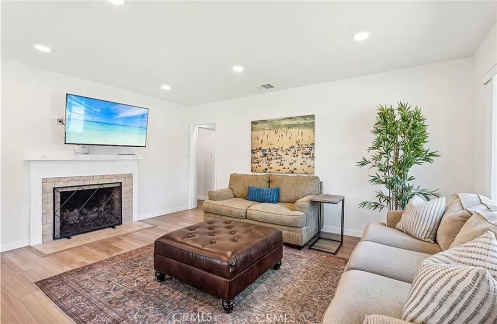 5340 East Mezzanine Way Long Beach, CA 90808 - Photo 3 of 18 a living room with furniture and a fireplace