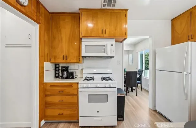a white kitchen with a stove top oven
