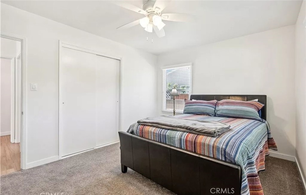 5340 East Mezzanine Way Long Beach, CA 90808 - Photo 10 of 18 a bedroom with bed and a chandelier