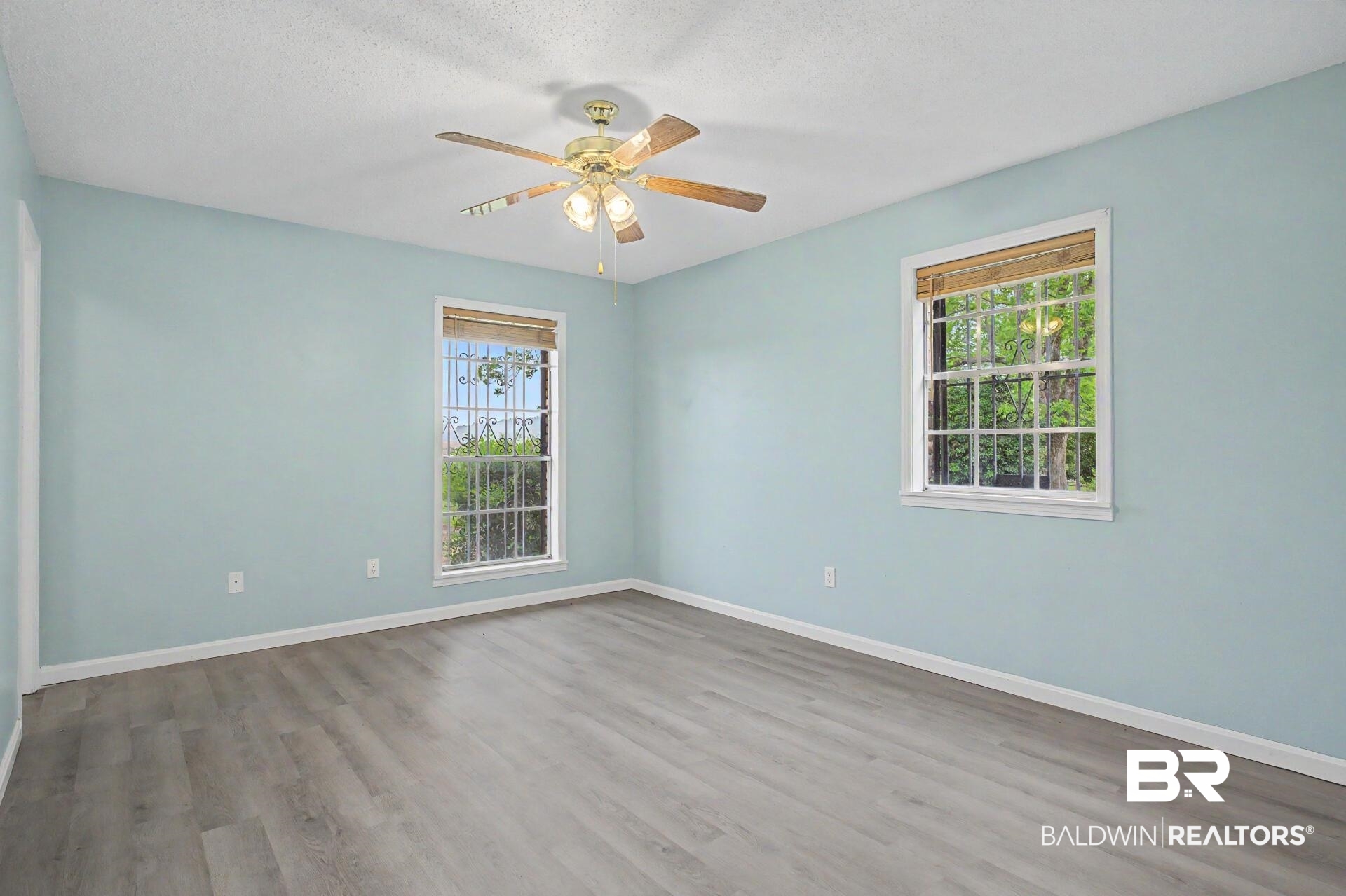 3791 Robinsonville Road Atmore, AL 36502 - Photo 42 of 47 Spacious room with light blue walls and wood-finish flooring