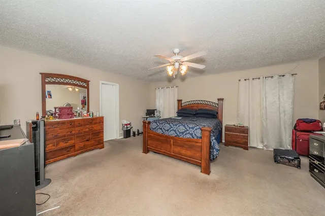 a bedroom with furniture and a chandelier
