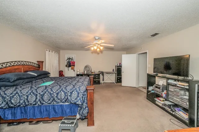 a bedroom with furniture and a flat screen tv