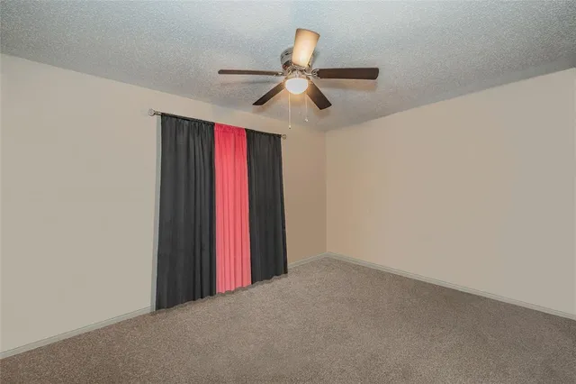 a view of a ceiling fan and a window