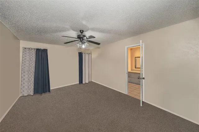 a view of a livingroom with a chandelier fan