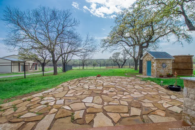 a view of a house with a backyard and a patio