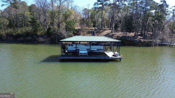 a view of a swimming pool and lounge chairs in back yard