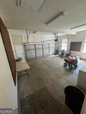 a view of a livingroom with furniture and white walls