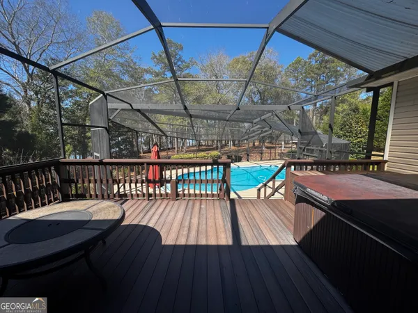 a balcony with wooden floor and outdoor seating