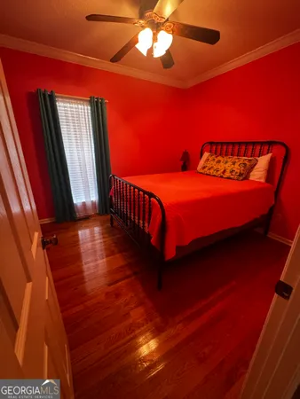 a bed sitting in a bedroom next to a window