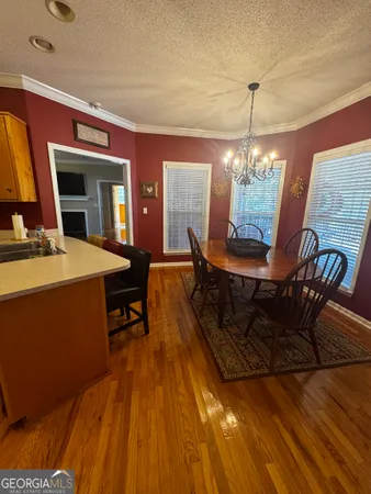 a view of a dining room with furniture and chandelier