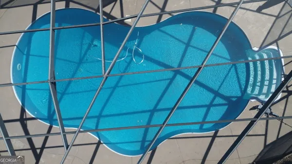 a view of a room with furniture and wooden stairs