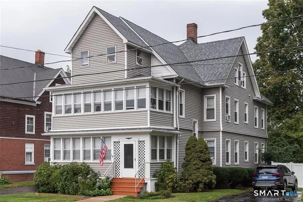 a front view of a residential apartment building with a yard