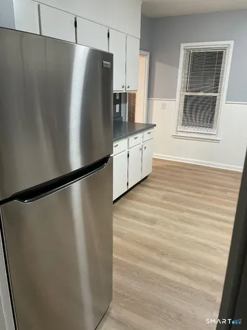 a white refrigerator freezer sitting inside of a kitchen