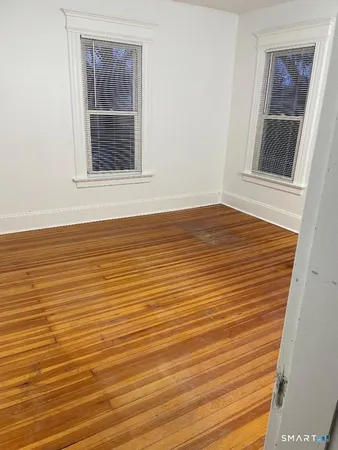 a view of empty room and wooden floor